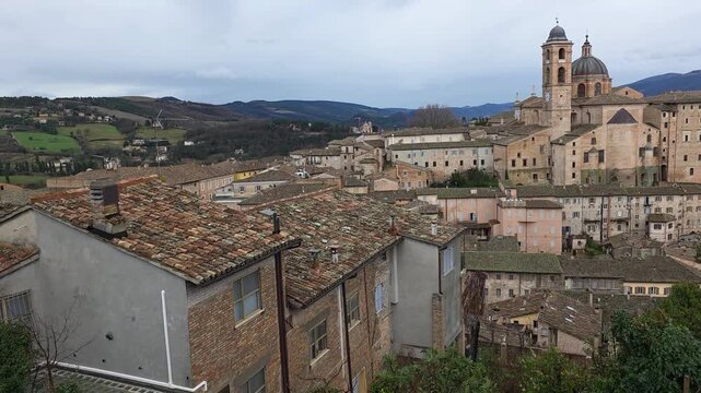 Panoramic view of the city of Urbino, Italy. Ancient italian renaissance city, Unesco world heritage site. Houses, palaces, cathedrals and towers of the Doge's Palace under a cloudy sky