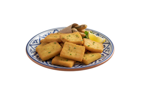 Classic Sicilian panelle served on a plate. A staple of Sicilian street food. White backdrop.

