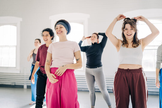 Diverse women enjoying dance class together laughing