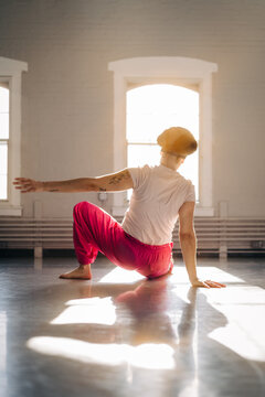 Dancer performing contemporary movement on studio floor