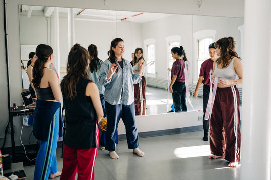Dance instructor teaching choreography to students in studio
