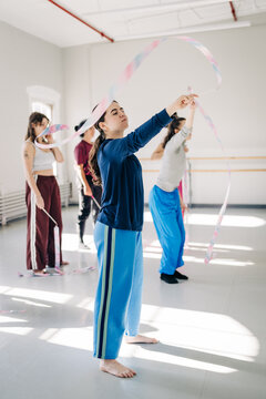 Young women training rhythmic gymnastics ribbon dance