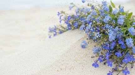 Obraz premium Bouquet of Blue Wildflowers Resting on White Beach Sand