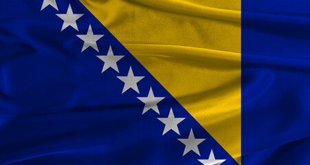 Flag of Bosnia and Herzegovina with fabric textured background. Close up of National flag of Bosnia and Herzegovina with realistic texture © IHERPHOTO