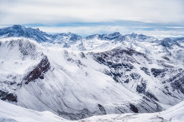 Scenic winter landscape with the snow covered Ausangate andean mountains seen from the hiking path to Vinicunca mountain also called Rainbow Mountain, in Peru