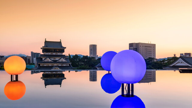 Kokura Castle and light up bulb with reflect on pond at sunset, Kitakyushu