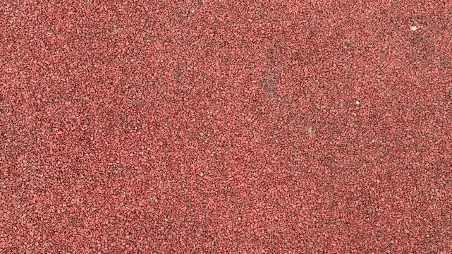 Red Gravel Surface, Compact Stones Create Sturdy Foundation, Earthy Tones With Fine Granules Ensure Durability, Slip resistant Gravel Provides Reliable Footing For Sports Facilities.