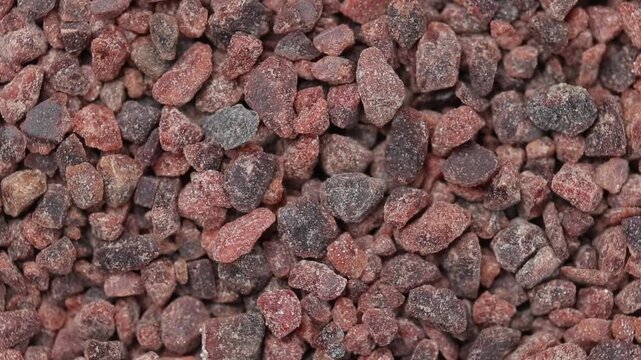 Pile of black himalayan salt rotating, Looping motion, Top view shot

