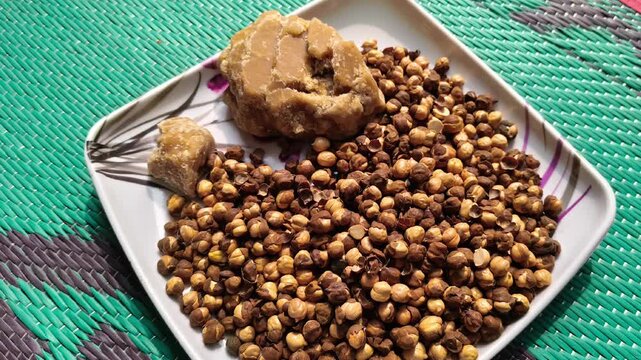 Traditional healthy Indian snack of roasted chickpeas and jaggery served on a plate