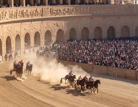 Epic horsedrawn chariot race in a grand stone arena. Dynamic action captures speed and power amidst a vast crowd. Perfect for historical, travel, and cultural storytelling projects.