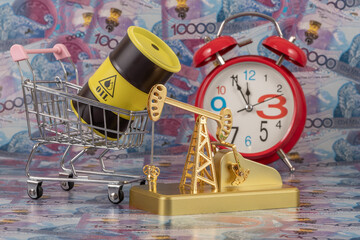 A gold oil pump and an iron barrel for oil products against a background of 10,000 Kazakhstani...