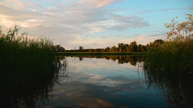 a beautiful sunset over a quiet lake in windless weather