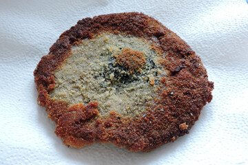 Fried breaded parasol mushroom cap on a white paper towel