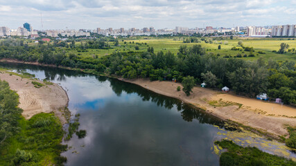 Fototapeta premium A drone view of the Ural River and the city of Orenburg on the horizon
