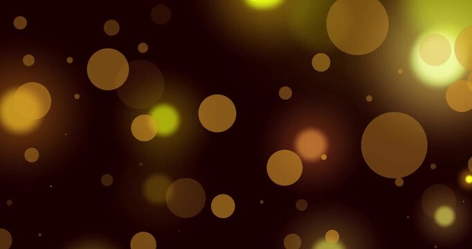 Animation of glowing yellow and orange spots of light against black background