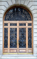 Ornate Stone Arch Window With Iron Bars