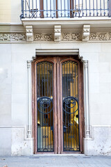 Tall wooden door framed by stone columns expressing classic craftsmanship strength and elegant historic building entrance