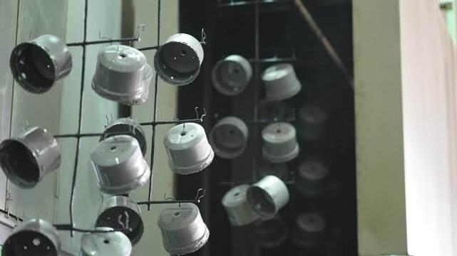 Suspended metallic cup array displayed in industrial design setting