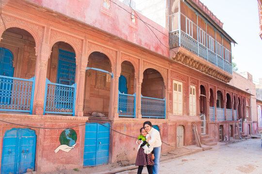 Mother daughter pose during trip to Rajasthan. Beautiful haveli at the background