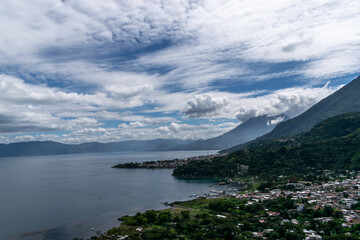 Panoramic dawn view of Lake Atitl&aacute;n with layered ridges fading into golden haze