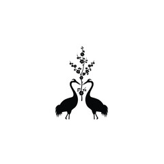 Fototapeta premium Two cranes and cherry blossoms forming a heart shape