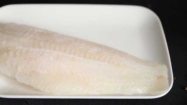 Frozen fish fillet white fish pangasius seafood tasty snack fresh gourme pescetarian diet food background on the table rustic food top view copy space keto and paleo diet food