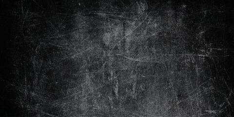 Vintage black grunge background with heavy white scratches a distressed chalkboard or worn metal look, perfect for creators looking to add grit. © Daiyan