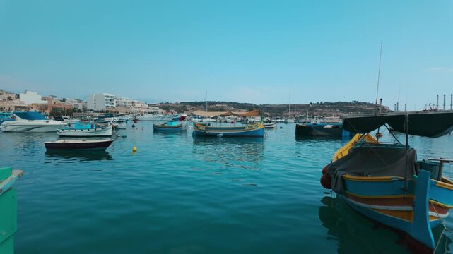 Marsaxlokk, a traditional seaside village famous for its colorful luzzu fishing boats.