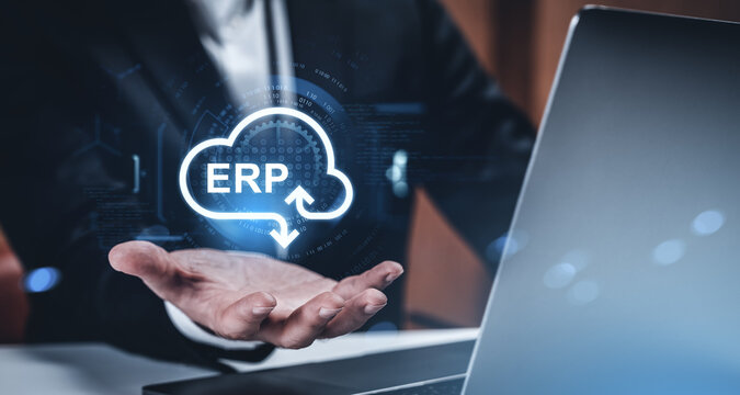 Businessman presenting ERP cloud system icon with holographic interface concept above hand, modern technology background in corporate setting.