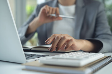 Businesswoman concentrate working on  laptop computer in office, searching the ideas, business solution at office, business planning, close up