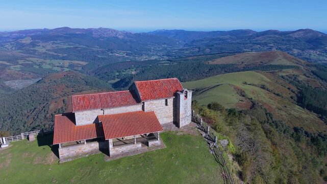 Aerial view from a drone of Mount Coliza (897 m) (Kolitza in Basque) with the chapel of San Sebasti&aacute;n and San Roque in the Ordunte Mountains in Valmaseda. Bizkaia, Basque Country, Spain.