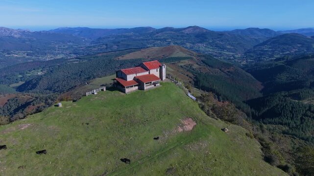 Aerial view from a drone of Mount Coliza (897 m) (Kolitza in Basque) with the chapel of San Sebasti&aacute;n and San Roque in the Ordunte Mountains in Valmaseda. Bizkaia, Basque Country, Spain.