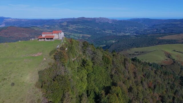 Aerial view from a drone of Mount Coliza (897 m) (Kolitza in Basque) with the chapel of San Sebasti&aacute;n and San Roque in the Ordunte Mountains in Valmaseda. Bizkaia, Basque Country, Spain.