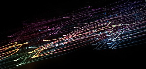 Night photography with selective focus and long exposure. Linear composition in motion. Abstract background, glowing lines. Copy space. Textures of light. Wrapper. Backing. Cover. A unique image.