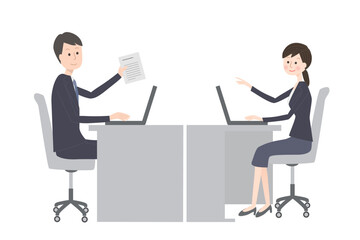 オフィスで仕事をするスーツ姿の男女