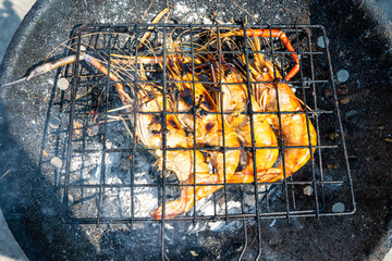 Big river prawn shrimp grilled on fire with smoke