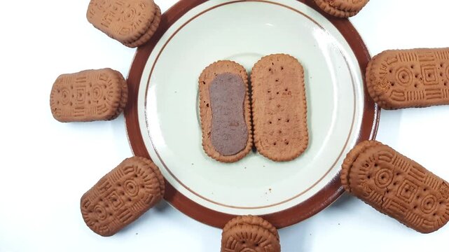 Rectangular chocolate cream sandwich biscuits arranged around a serving plate