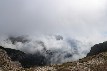Alpine massif detail shrouded in fog and clouds