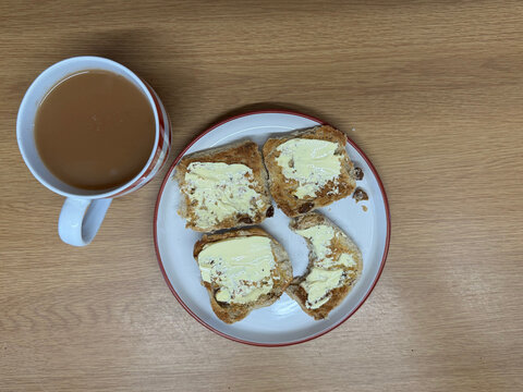 Hot Cross Buns with Bite and Mug of Tea