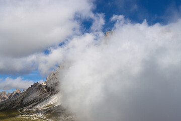 Silent Dolomites guardians veiled in mountain fog