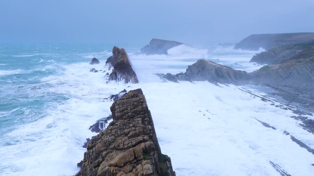 Storm and high waves in the Cantabrian Sea in the Liencres Natural Park within the Costa Quebrada Geopark. Liencres, Cantabria, Spain, Europe