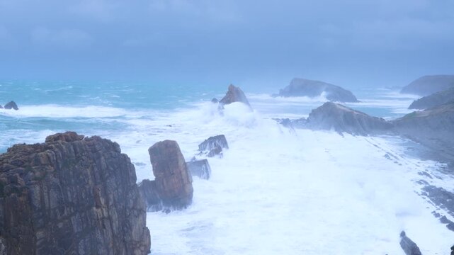 Storm and high waves in the Cantabrian Sea in the Liencres Natural Park within the Costa Quebrada Geopark. Liencres, Cantabria, Spain, Europe