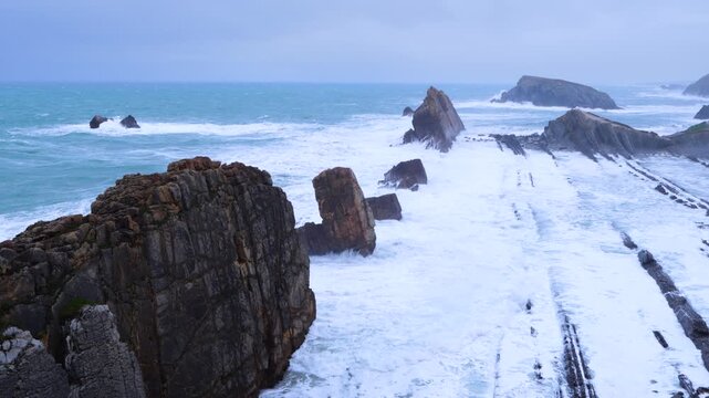 Storm and high waves in the Cantabrian Sea in the Liencres Natural Park within the Costa Quebrada Geopark. Liencres, Cantabria, Spain, Europe