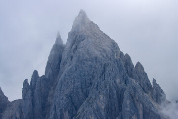 Dolomites dreamscape: Cadini peaks fading into clouds