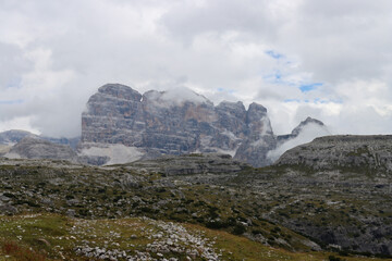 Tre Cime di Lavaredo Dolomites landscape with peaks shrouded in mist and clouds