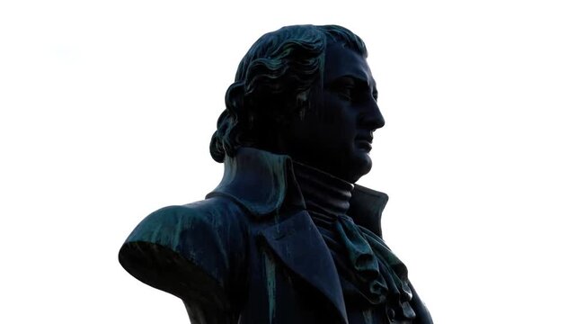 A bronze bust of a historical figure silhouetted against a bright sky, shifting in exposure between deep shadows and brief moments of bright lens flare over eight seconds.