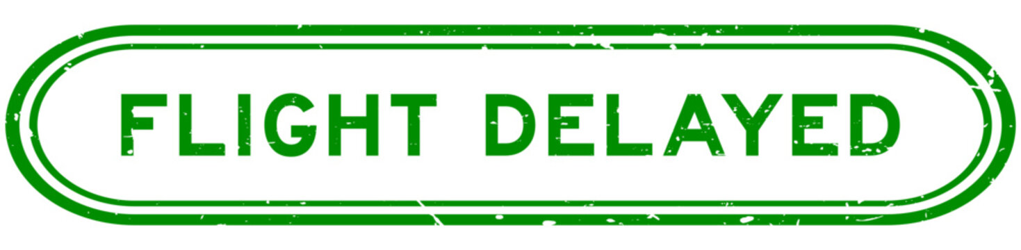 Grunge green flight delayed word rubber seal stamp on white background