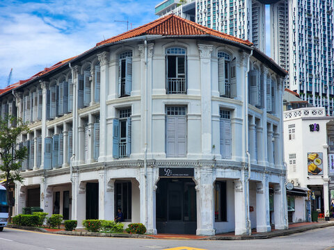 Singapore - June 01, 2024 : The beautiful heritage shophouse architecture on Keong Saik Road features classic white facades and traditional shutters under a bright blue sky in the historic district.