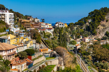 Fototapeta premium Panoramic view of Taormina and Mazzaro town at Ionian sea shore seen from Funivia Cable Car gondola in Messina region of Sicily in Italy