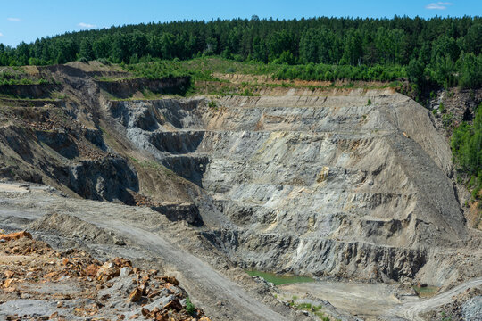 The production of graphite. Deep quarry for the extraction of minerals.